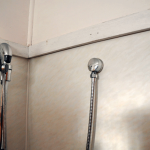 Tilux walling in shower recess. Tilux can be found in bathrooms and laundries and was used in place of ceramic tiles in bathrooms. It is an extremely hard, waterproof material usually with a pattern design. The colour of the design is most commonly: brown, olive, pink, yellow or blue; other colours can be found. AAG-Prod-Loc14