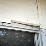 Damaged fibro sheeting above window AAG-Prod-Loc43