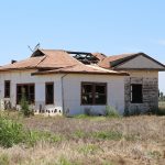 Abandoned fibro house with broken fibro