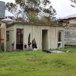 Abandoned building structure on farm with broken fibro and paint deteriorating