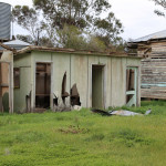 Abandoned building structure on farm with broken fibro and paint deteriorating