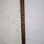 Asbestos lagging around pipe under kitchen sink.