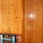 Internal wood cladding over ACM wall with fireplace